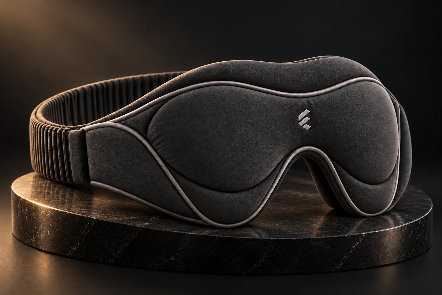 NIGHT 02 graphite sleep mask with sculpted cushioning, in warm studio light